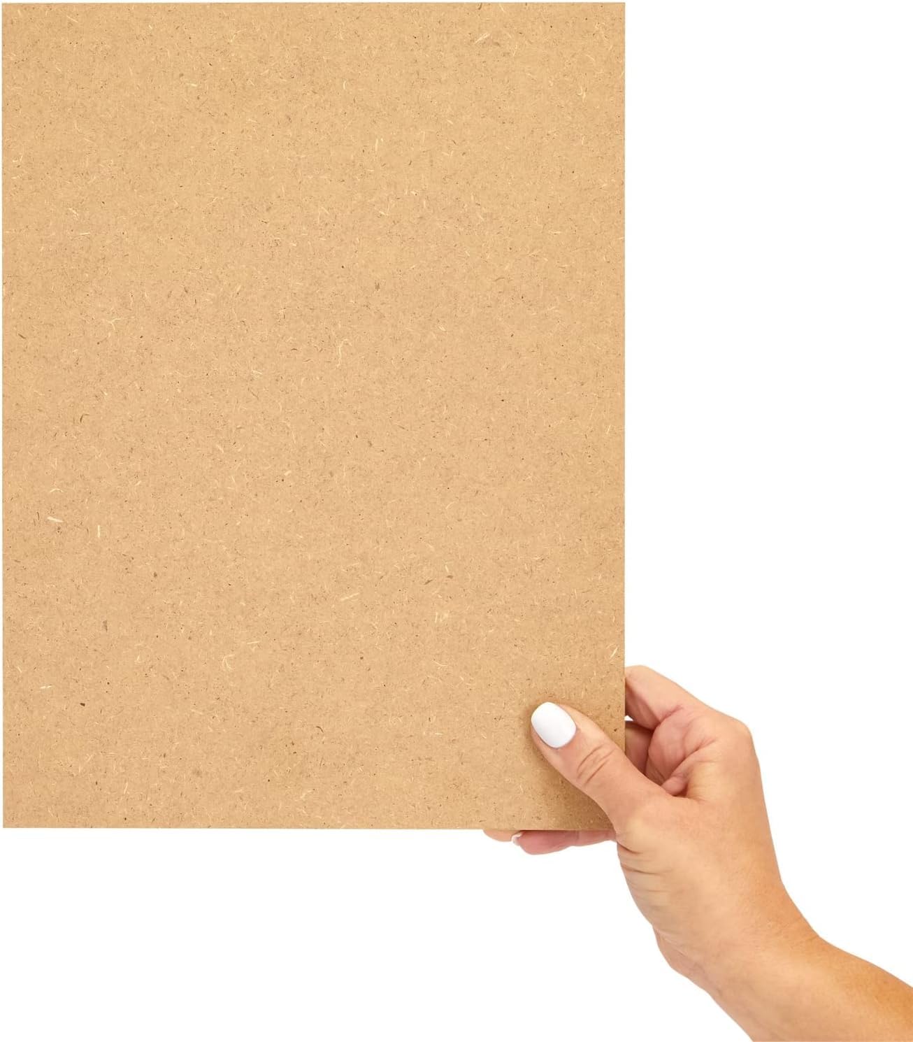 Hand holding a sheet of brown cardboard against a white background