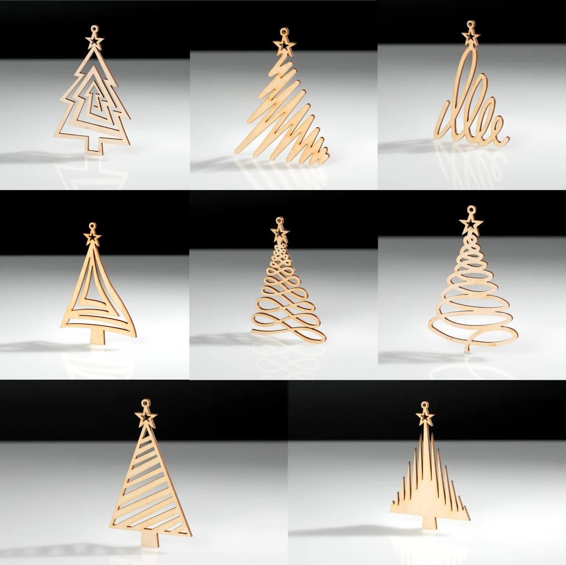 Set of gold Christmas tree-shaped table decorations on a reflective surface with a black background.