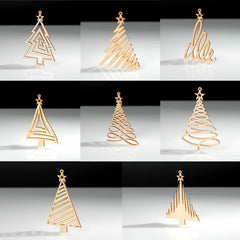 Set of gold Christmas tree-shaped table decorations on a reflective surface with a black background.