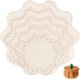 Set of beige doily placemats with a small crochet pumpkin on a white background