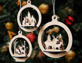 Wooden Christmas ornaments with cut-out scenes of a village and deer on a tree background.