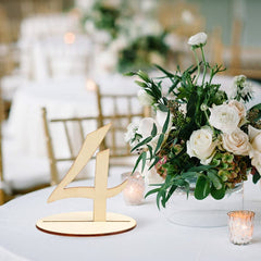 Decorative table number '4' with floral arrangement on a table in a banquet hall.