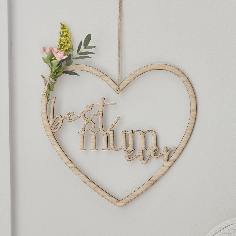 Heart-shaped wooden sign with 'best mum ever' text and floral decoration on a light background