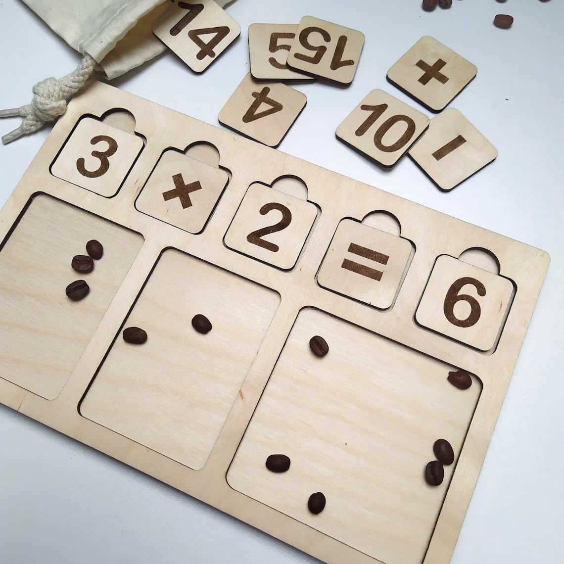 Wooden educational puzzle with numbers and mathematical symbols, accompanied by scattered beans on a light background.