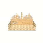 Decorative cake topper with 'Eid Mubarak' text and architectural design on a white background