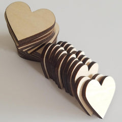 Stack of wooden heart-shaped objects on a light gray background