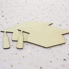 Graduation cap cutout on a decorative background with stars and confetti
