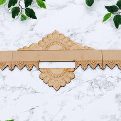 Decorative wooden border with floral patterns on a marble surface
