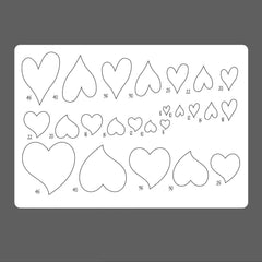 Sheet of heart-shaped templates with measurements on a gray background