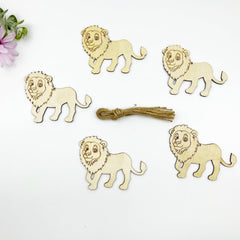 Five wooden lion figurines with a bundle of twine on a white background