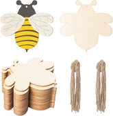Wooden bee-shaped cutouts with yellow and black stripes, plain white ones, and string for hanging on a white background.