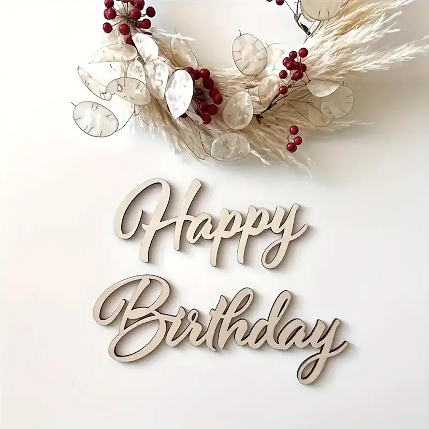 Wooden 'Happy Birthday' sign with decorative elements on a light background