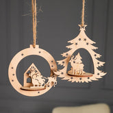 Wooden Christmas tree and house decorations hanging on a dark background