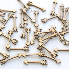 Wooden arrow-shaped objects scattered on a white background