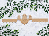 Decorative wooden panel with arches on a white marble background with green leaf patterns.