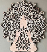 Decorative wall art with a mandala design featuring a silhouette of a person in a meditative pose on a gray background.