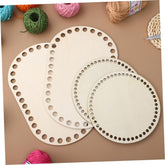 Three wooden lace-making boards with holes on a brown surface with yarn balls.