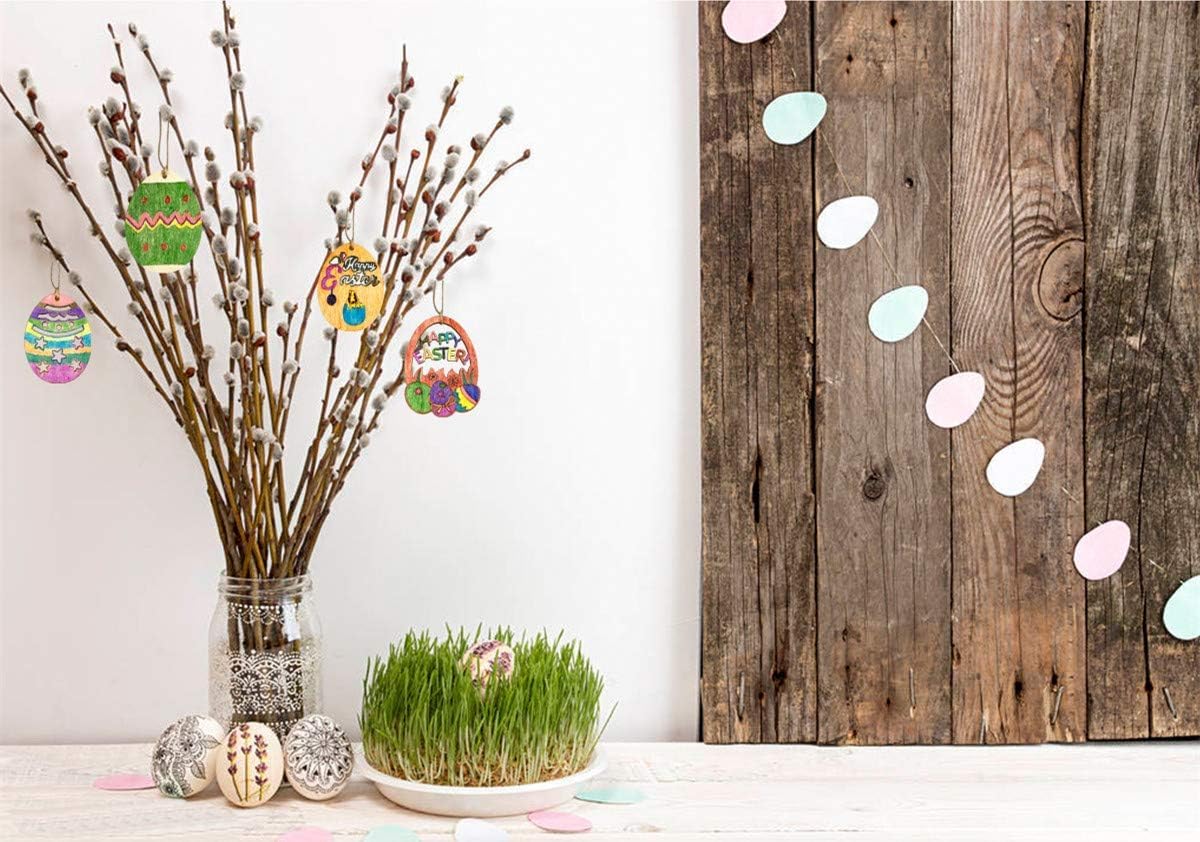 Decorative setup with Easter eggs on twigs, a wooden board with painted eggs, and a small plant.