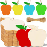 Colorful apple-shaped wooden tags with jute ropes and a bow on a white background