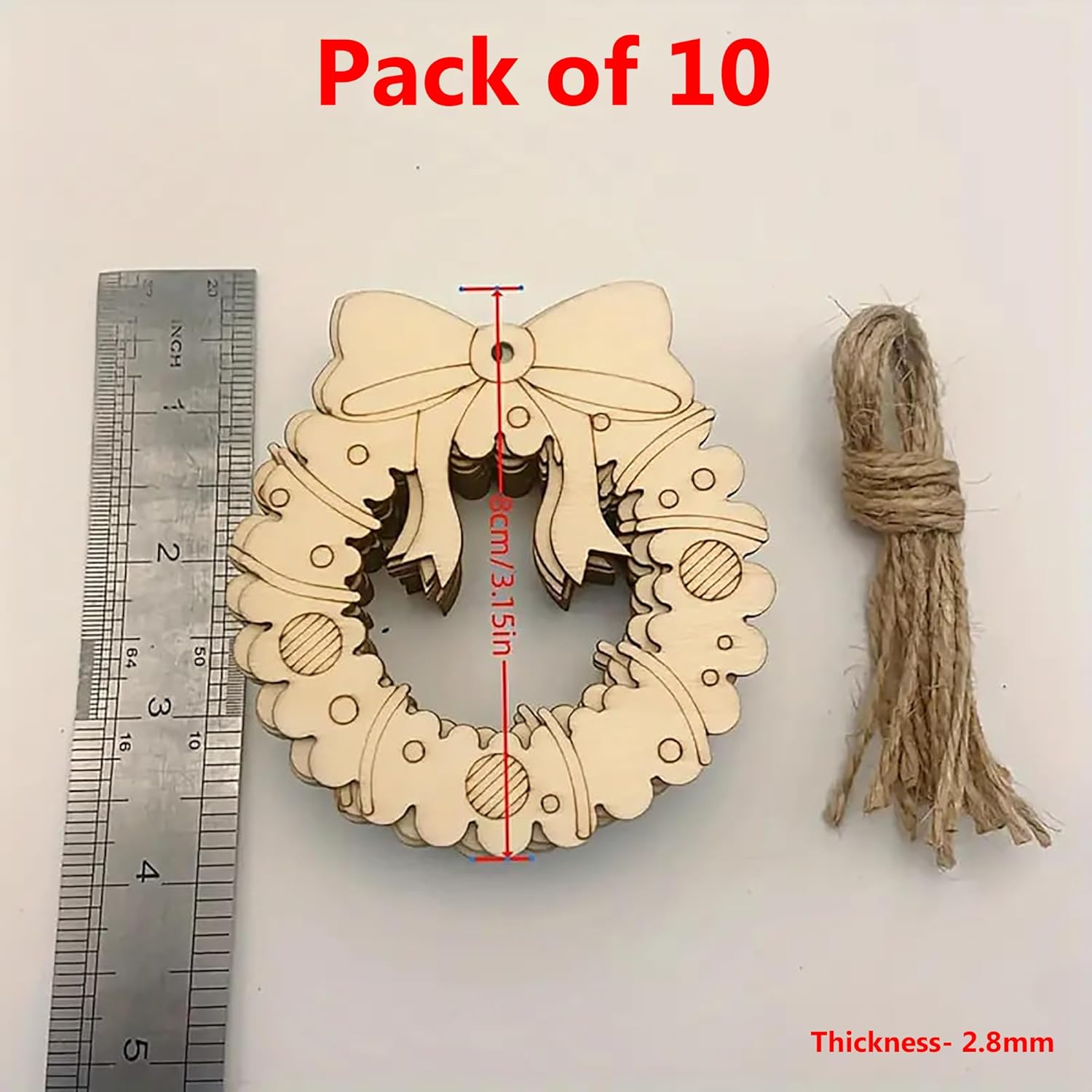 Wooden wreath ornament with bow, twine, and ruler for scale on a white background