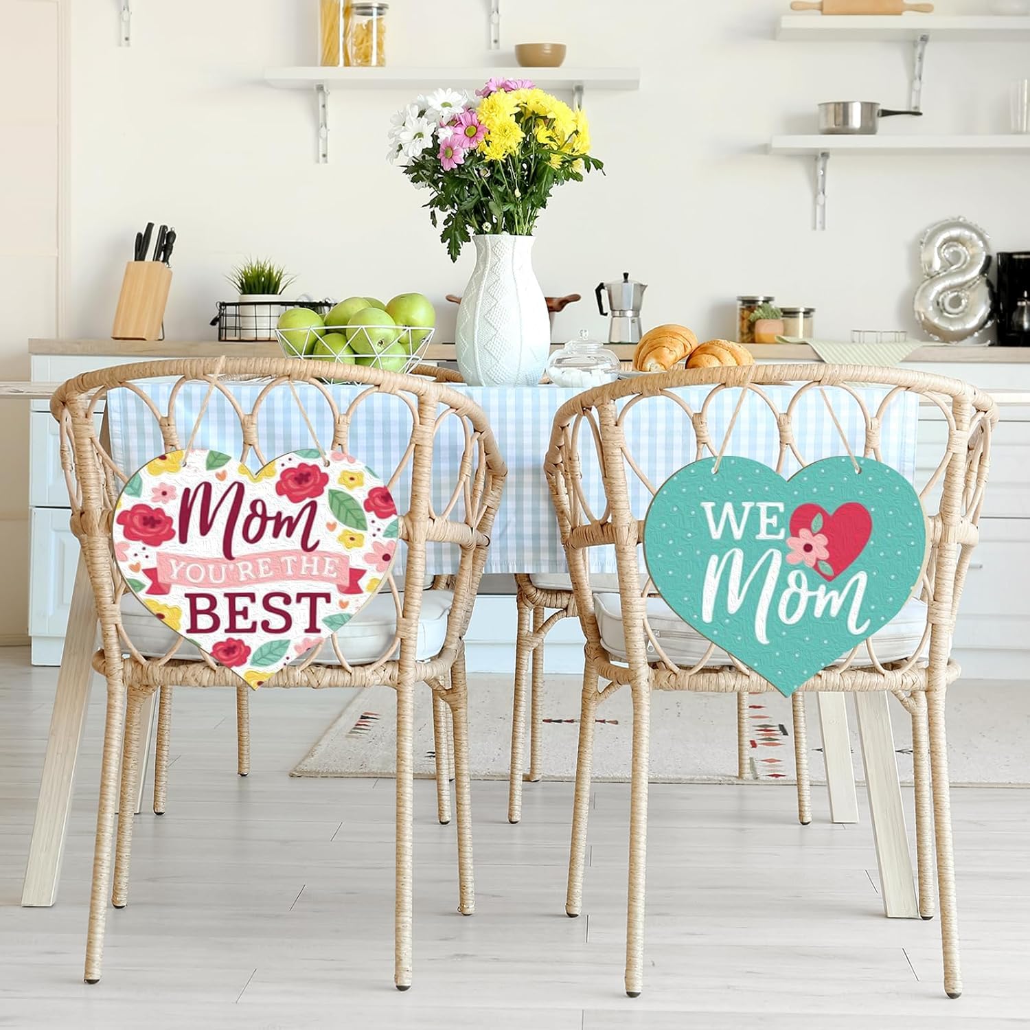 Two chairs with decorative signs in a kitchen setting