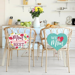 Two chairs with decorative signs in a kitchen setting