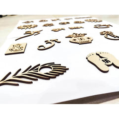 Wooden cutouts of various shapes and designs on a white surface