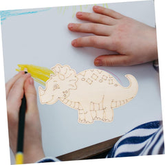 Child drawing a dinosaur with a yellow crayon on a white sheet of paper.