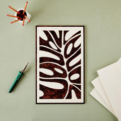 Decorative wall art with tribal design on a light green background