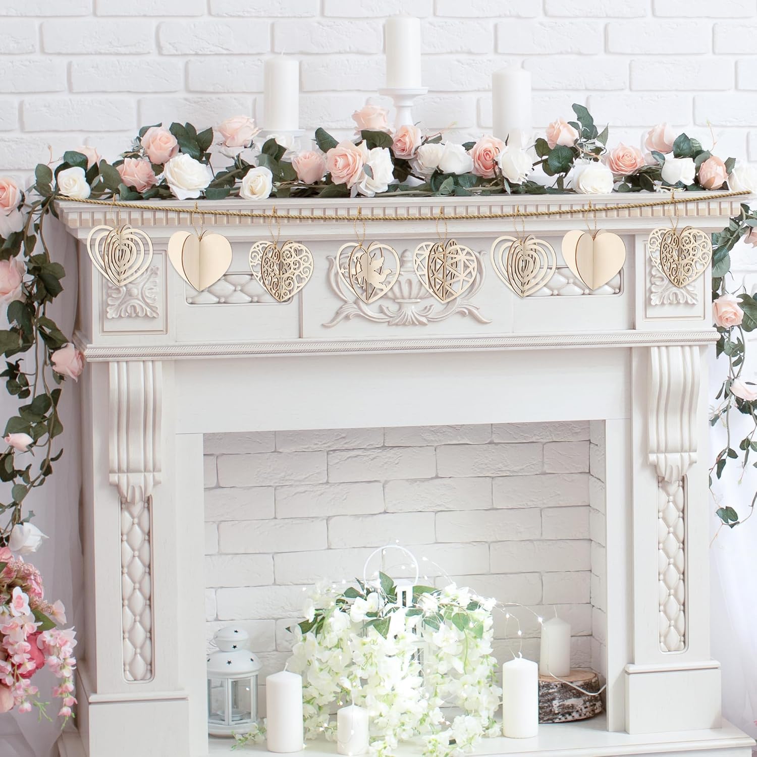 Decorative fireplace with floral garland and candles against a white brick wall.