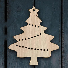 Wooden Christmas tree ornament with star on a dark wooden background