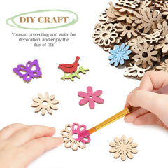 Wooden craft pieces with colorful paint and a hand holding a paintbrush on a white background.