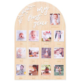 Wooden photo display with 'my first year' text and baby photos.