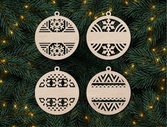 Four wooden Christmas ornaments with geometric patterns on a green pine branch background.