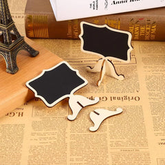 Two small blackboards on stands with a miniature Eiffel Tower model on a newspaper background.