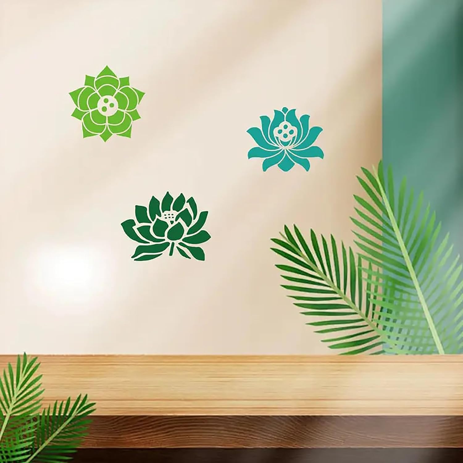 Decorative wall stickers of green and blue lotus flowers on a beige wall with wooden shelf and leaves.
