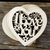 Wooden heart-shaped cutout with 'I Love You' text on a wooden surface