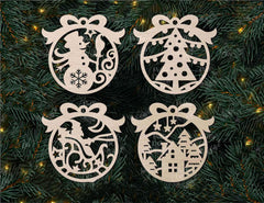 Four decorative Christmas ornaments on a green pine branch background