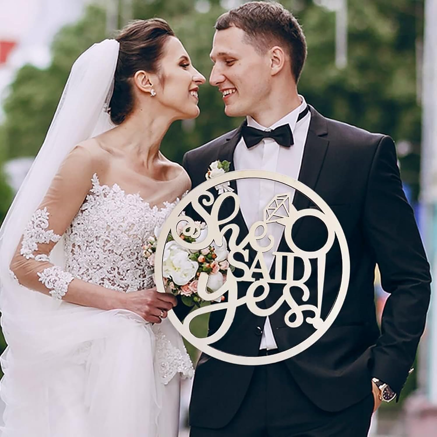 Wedding couple with a decorative sign in the foreground