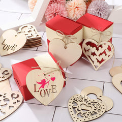 Heart-shaped wooden decorations with 'LOVE' and floral elements on a white surface