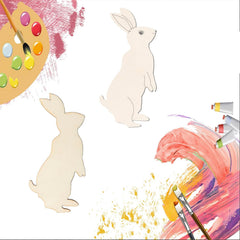 Two wooden rabbit shapes with a paint palette and brushes on a white background