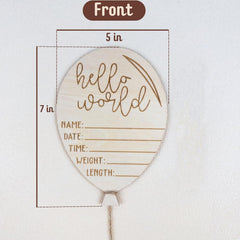 Wooden balloon-shaped sign with 'hello world' text and measurement details on a white background.