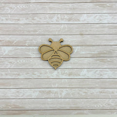 Wooden bee-shaped cutout on a wooden surface