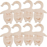 Set of wooden baby size dividers shaped like penguins with age markings on a white background.