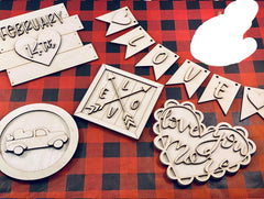 Wooden decorative items with 'LOVE' and other inscriptions on a red and black checkered background
