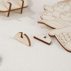 Wooden puzzle pieces on a white surface