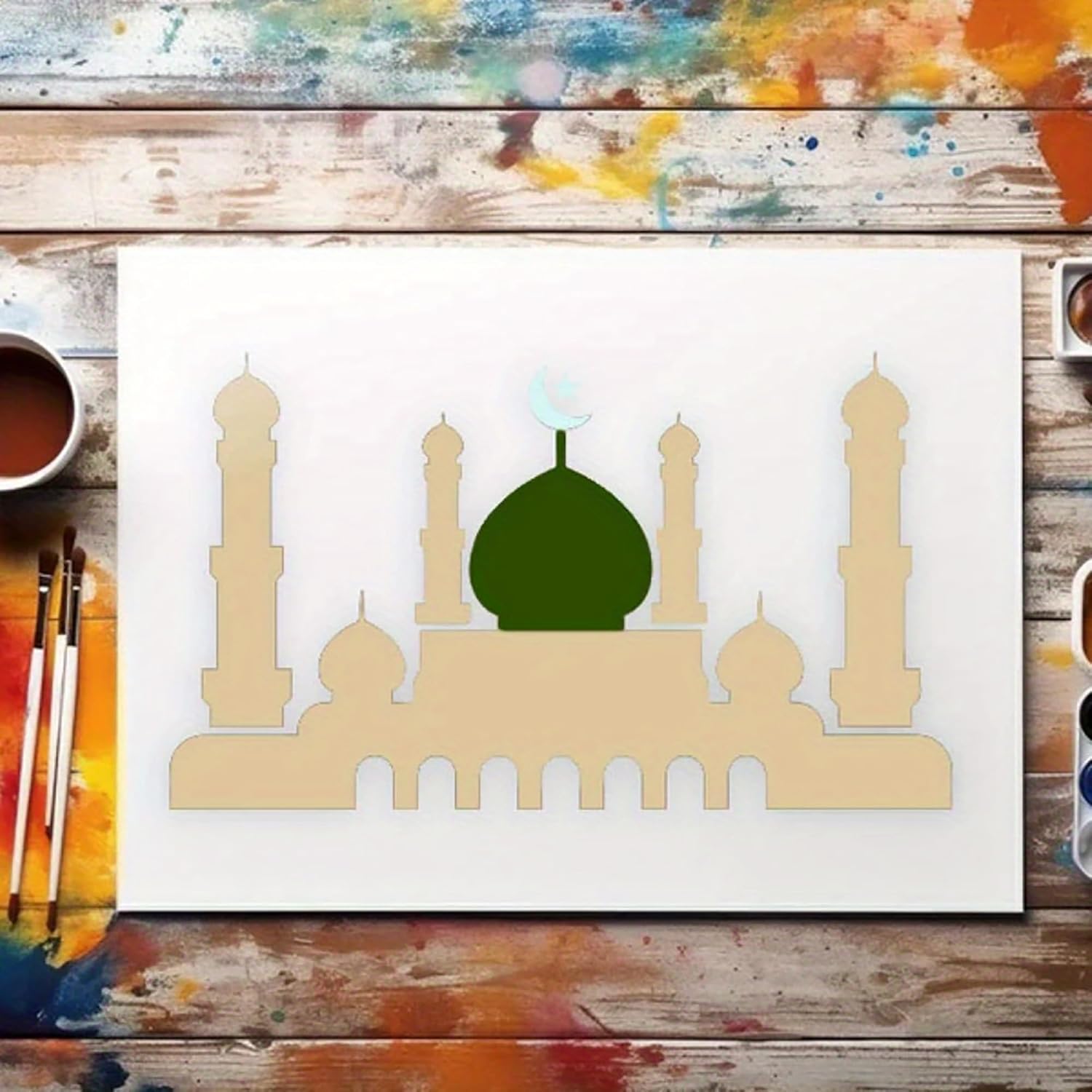 Artistic depiction of a mosque with a green dome on a white background, surrounded by art supplies.
