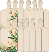 Set of six wooden cutting boards with floral designs on a white background