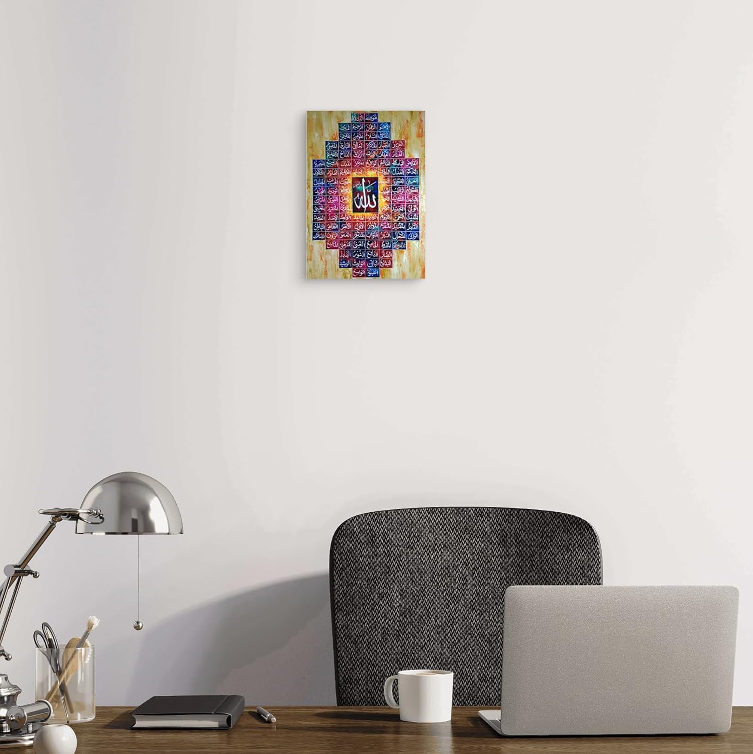 Colorful abstract painting on a white wall above a desk with a laptop and lamp.