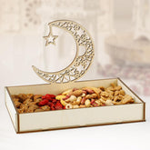 Decorative tray with assorted nuts and dried fruits, topped with a wooden moon and star design.